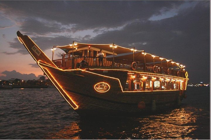 Experience the magic of Dubai Creek on a traditional dhow feasting on a delightful buffet while enjoying enchanting views and captivating entertainment under the night sky.